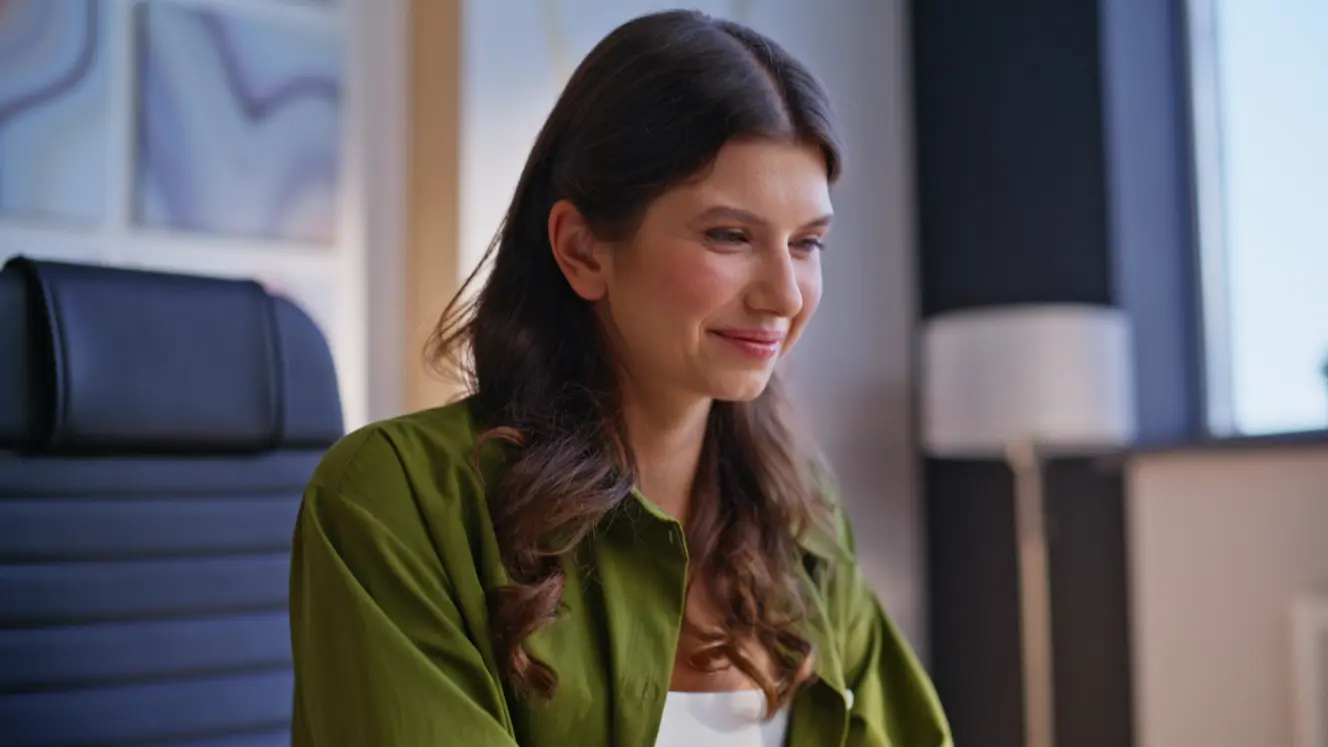 Female sits down during an online therapy session.